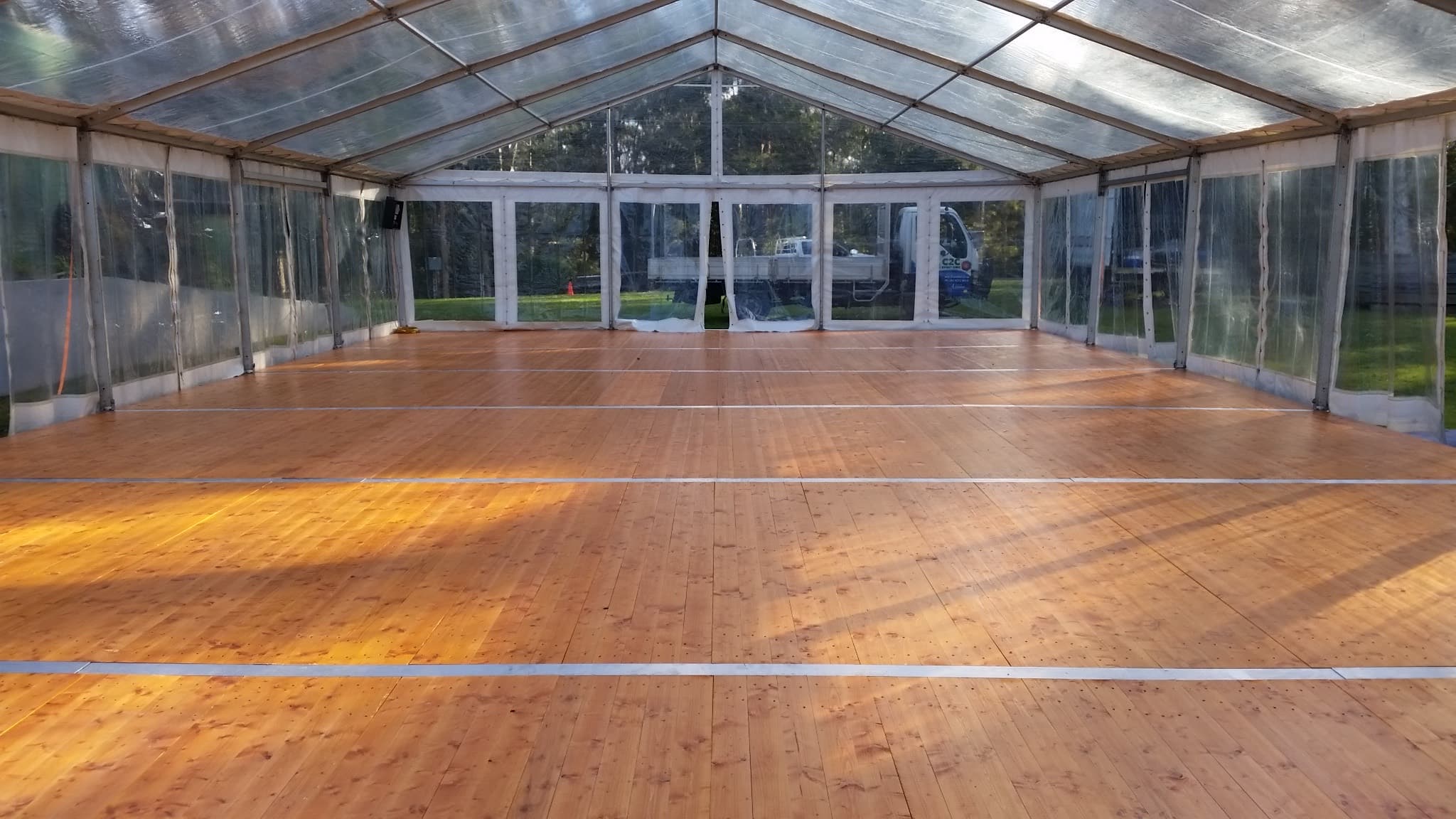 Timber marquee flooring laid wall to wall inside a 10 m marquee