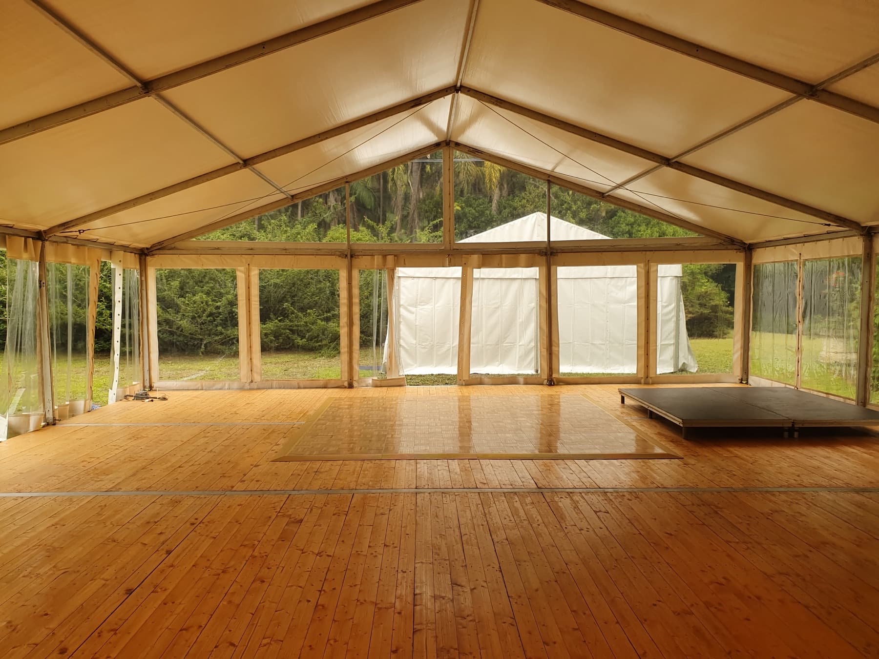 Marquee interior with timber flooring and a clear gable end