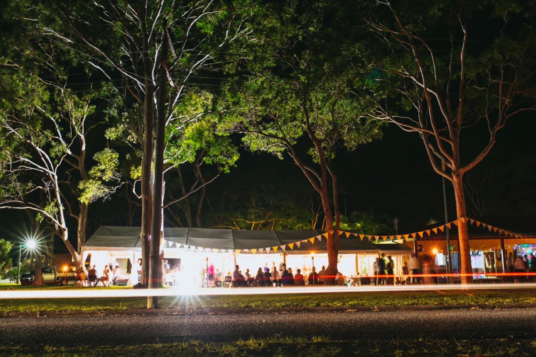 Marquee lit with festoon lighting at night