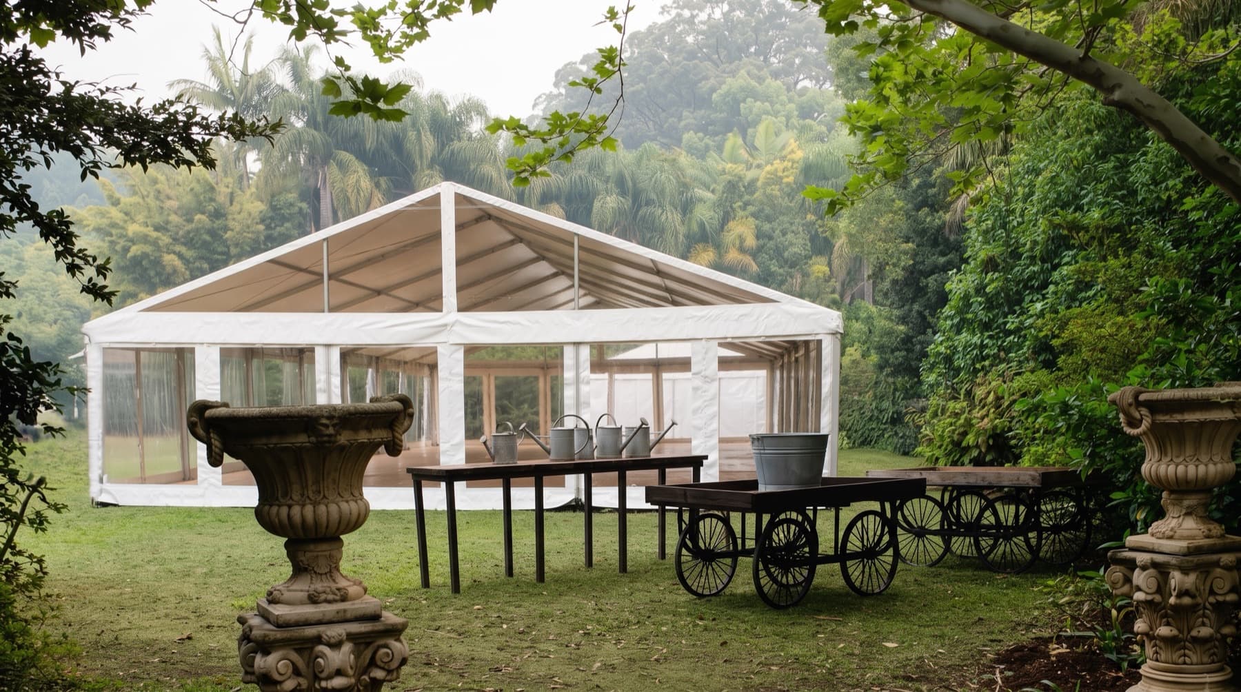 Clear gable marquee pitched on a lawn in a subtropical garden