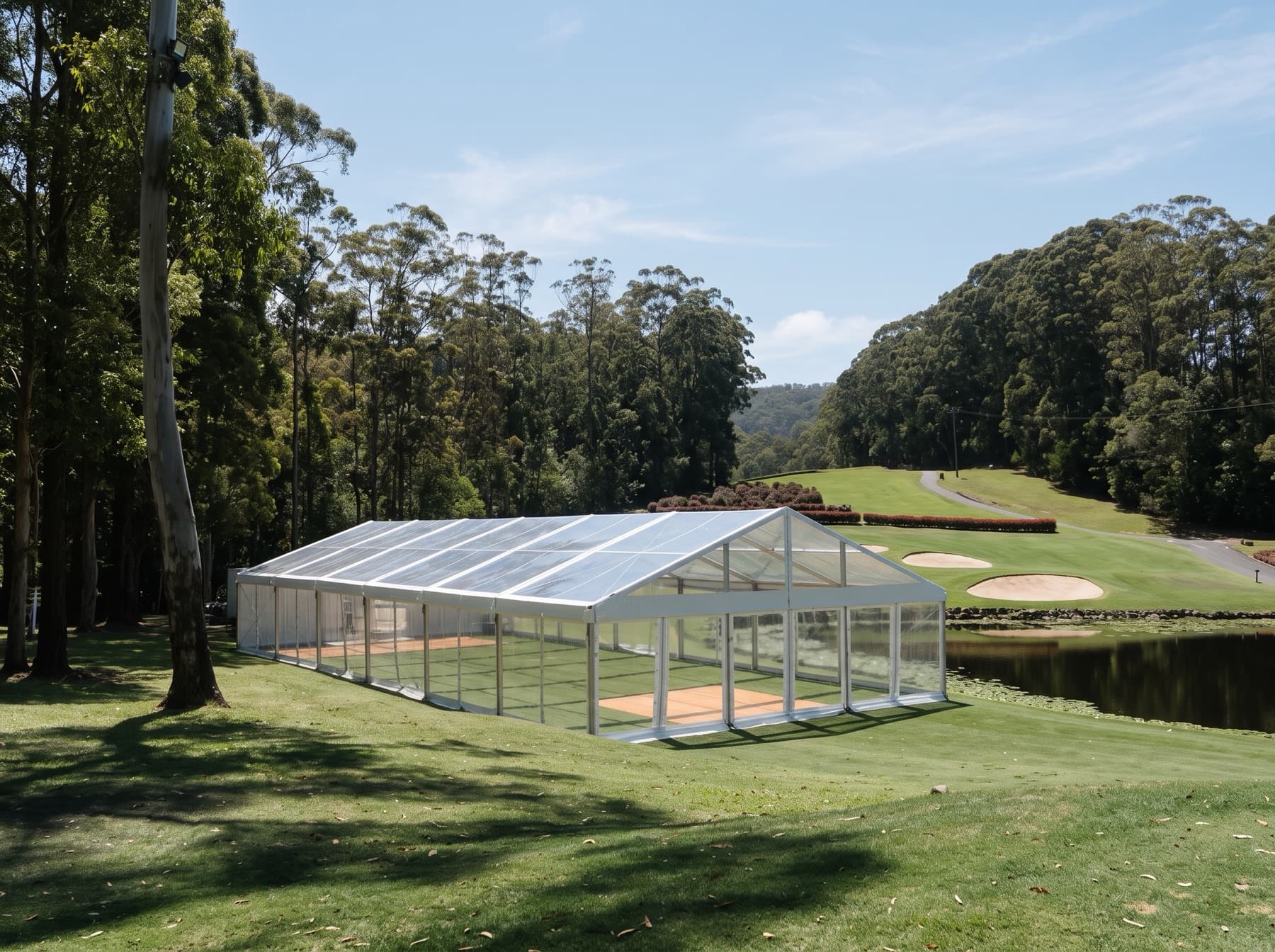 Clear-roof marquee set up on a coastal golf course fairway